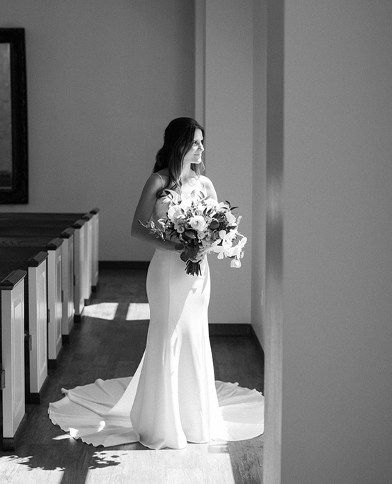 Black and White Photo of a bride in The Chapel gazing out the window.