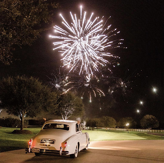 Vintage White Car beneath the fireworks exiting Briscoe Manor