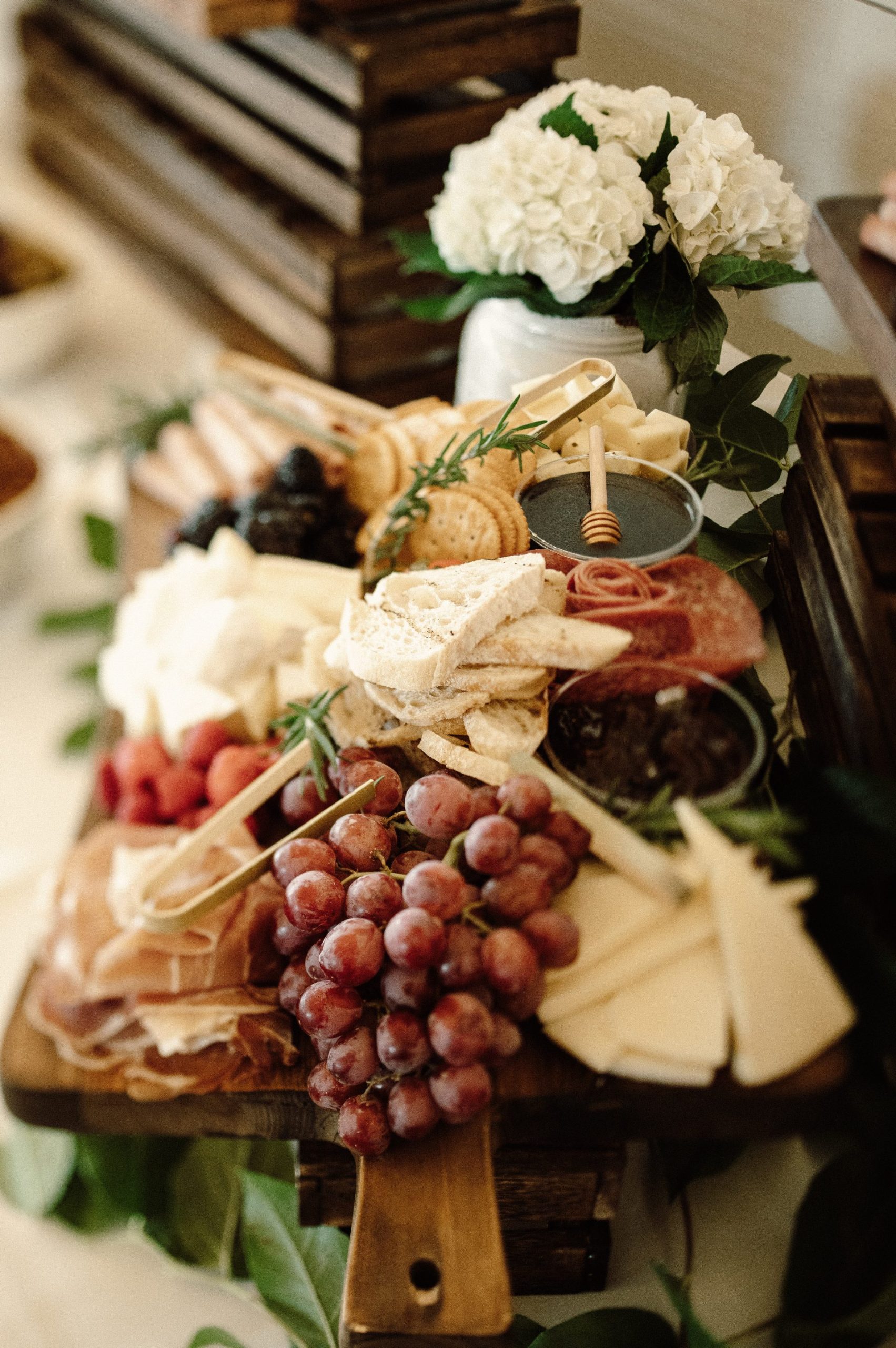 Charcuterie Display with various cheeses, grapes, meats, crackers and sauces
